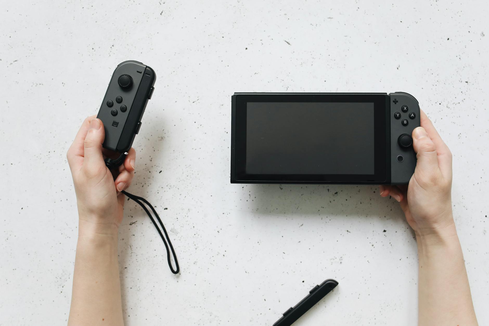 hands holding black nintendo switch